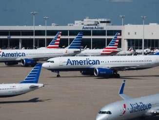 JetBlue and American Airlines planes parked at terminal