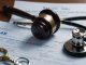 Gavel and stethoscope on medical bills, legal action